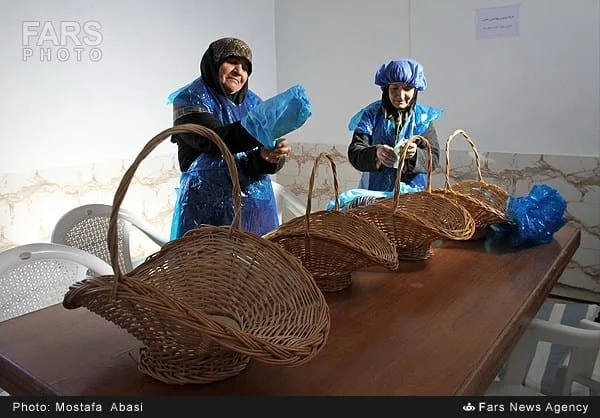 Workers preparing baskets and trays at a saffron workshop