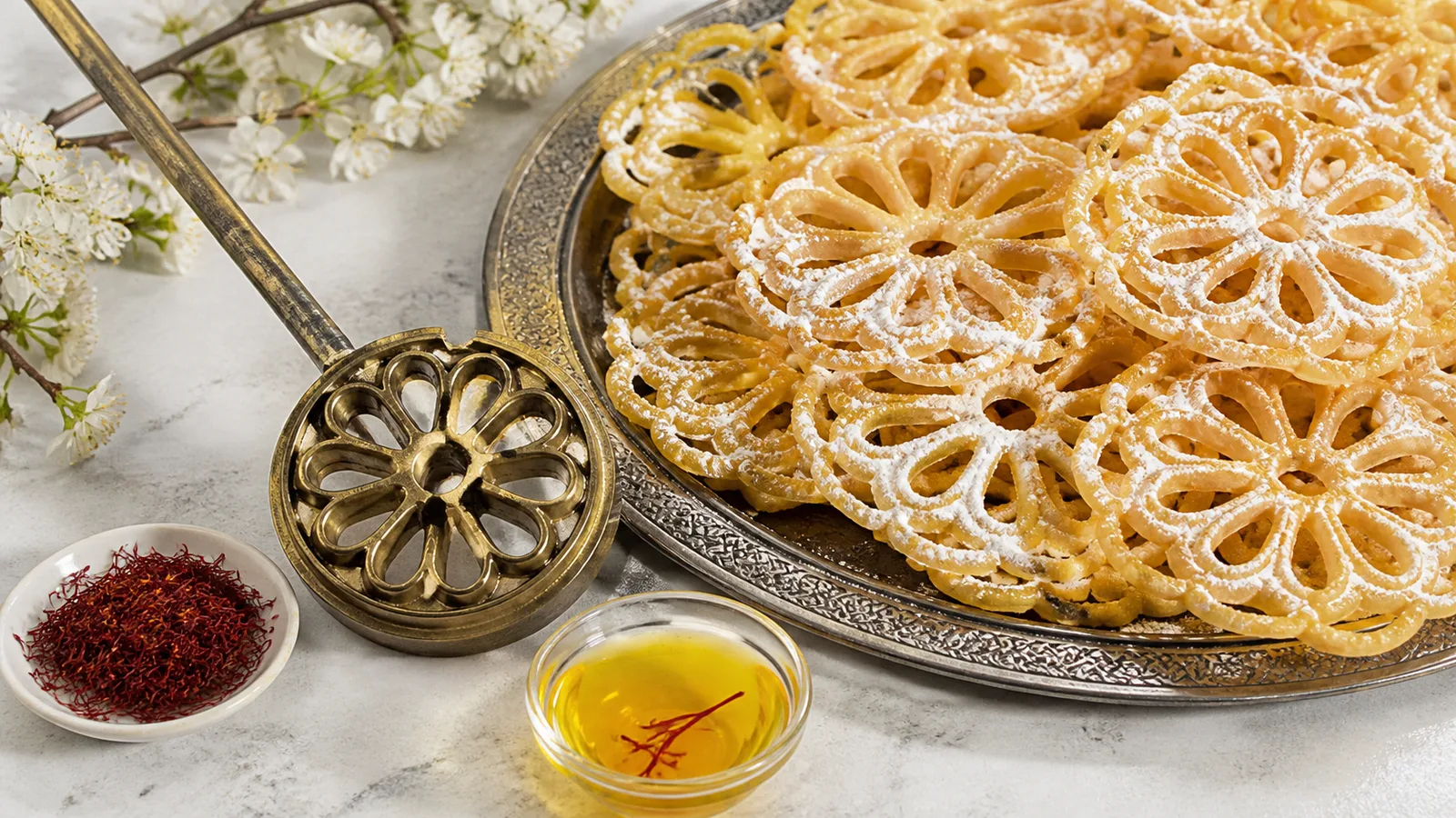 Iranian saffron window bread sweets with a traditional rosette iron