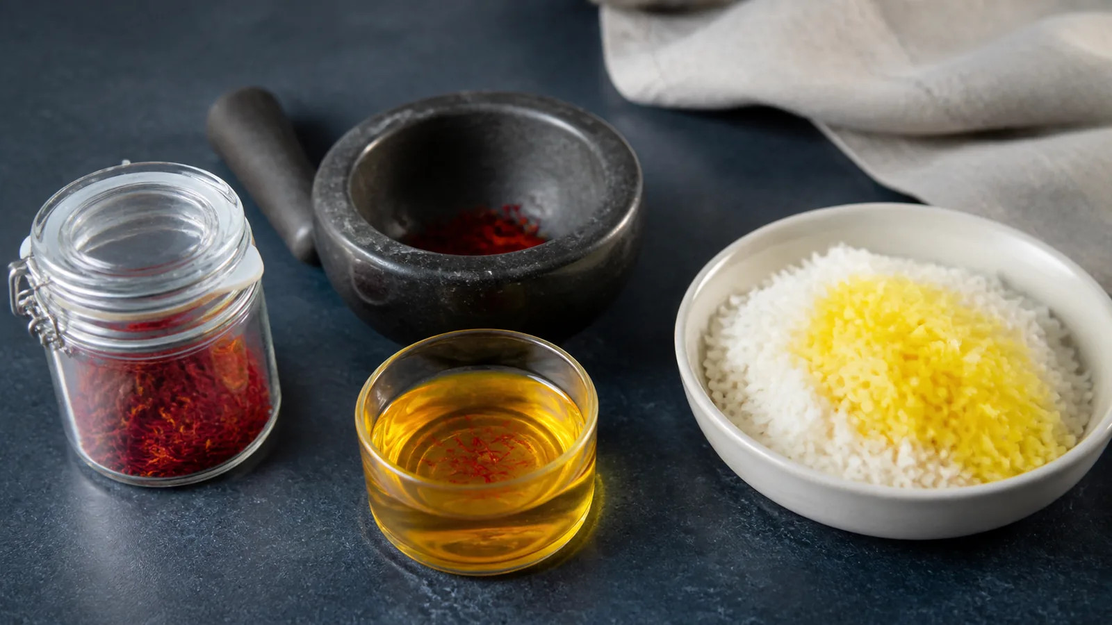 Saffron threads, a warm golden infusion and rice arranged as a simple beginner cooking setup