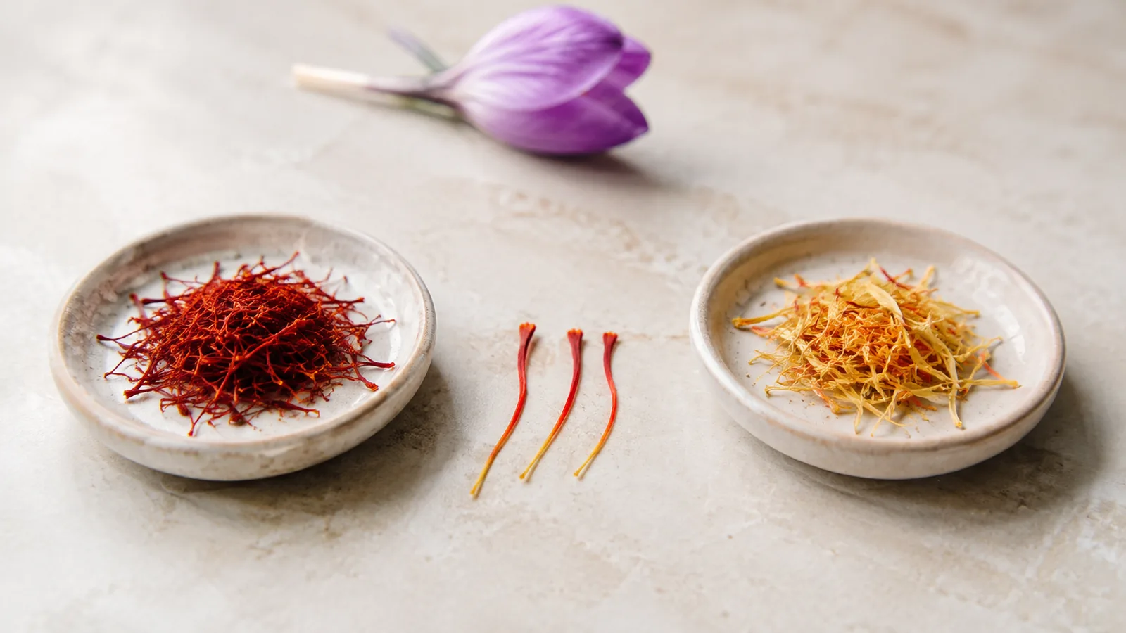Red saffron stigmas beside pale yellow saffron style portions