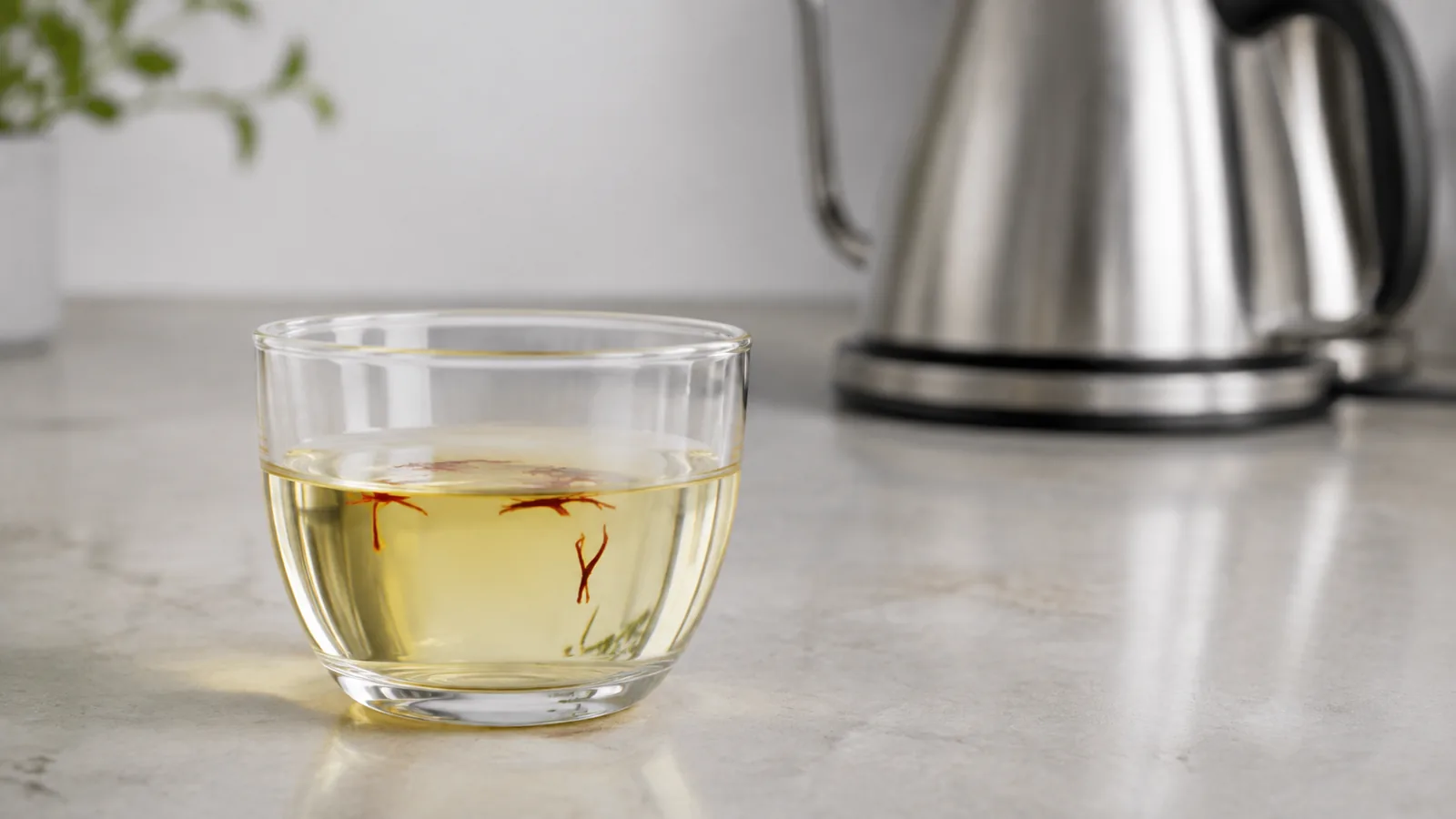 Pale-golden saffron infusion beside a temperature-control kettle